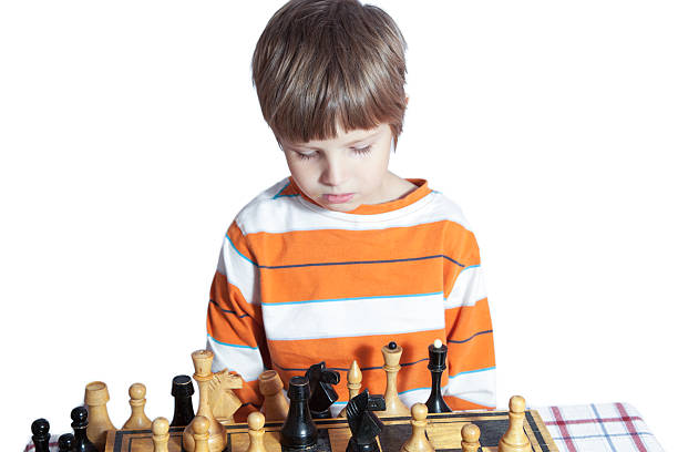 istock Portrait of a little boy playing chess 610880246