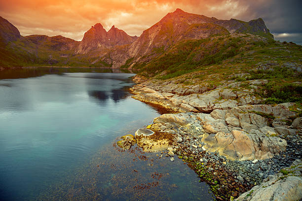 istock Fjord at sunset, Rocky beach in evening, Norway 610880646