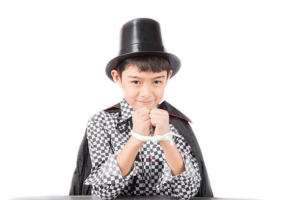 istock Little boy pretend as a magician performance with fun 610882078