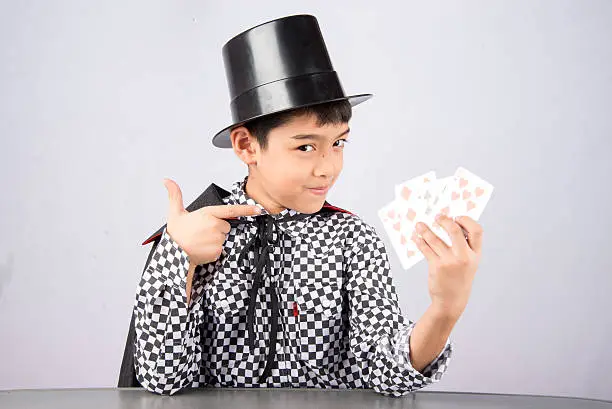 Little boy pretend as a magician performance with fun