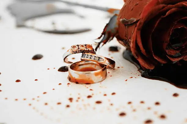 Photo of Bleeding Rose With Wedding Rings