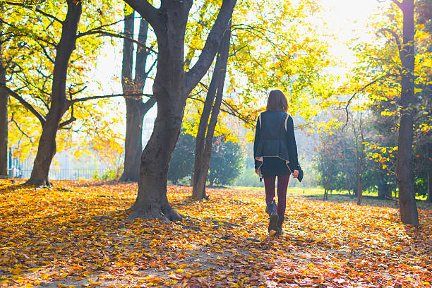 istock Young woman walking at park 610883950