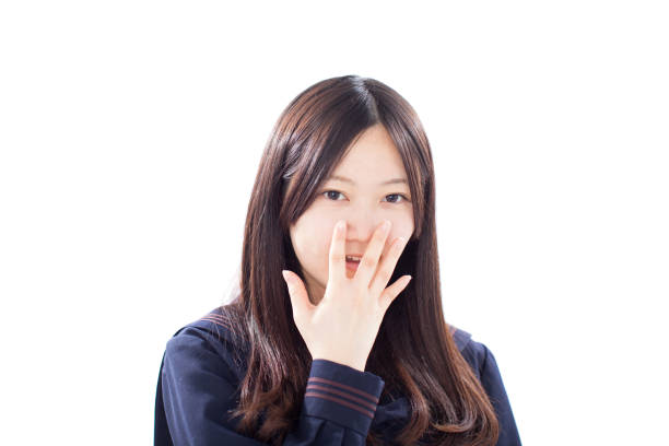 istock Japanese school girl making gestures in winter uniform 610943610