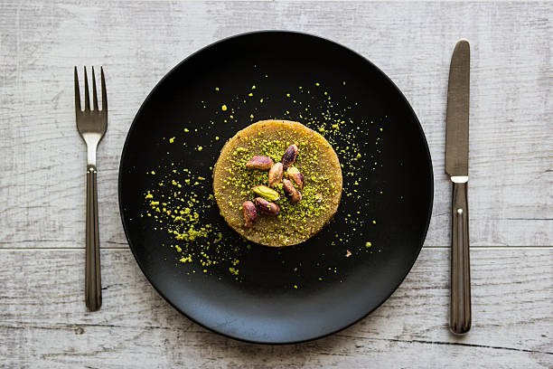 istock Turkish Dessert irmik helvasi with pistachio powder 610944192