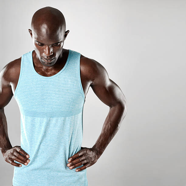 istock African man with bald head and muscular arms 610945718