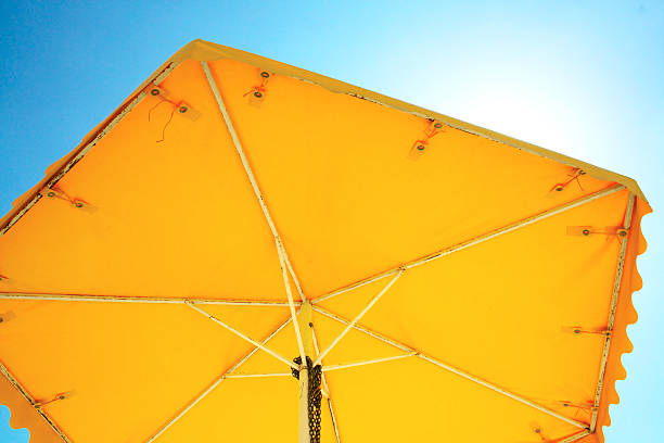 istock yellow umbrella from the sun 610947628