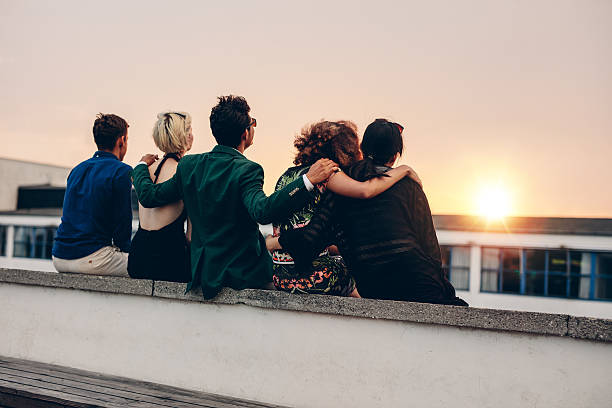 istock Friends relaxing on terrace in evening 610947970
