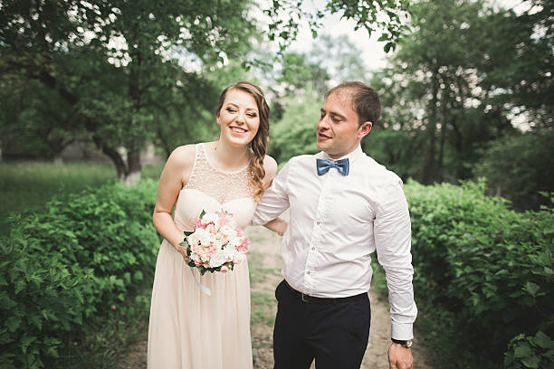 istock Luxury married wedding couple, bride and groom posing in park 610948102