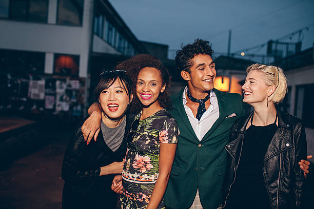 istock Friends walking down street in the evening 610948366