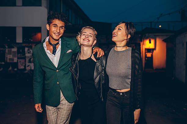 istock Friends walking down street in the evening 610948478