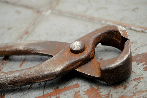 istock Old pliers on a rusty scratched metal 610949064