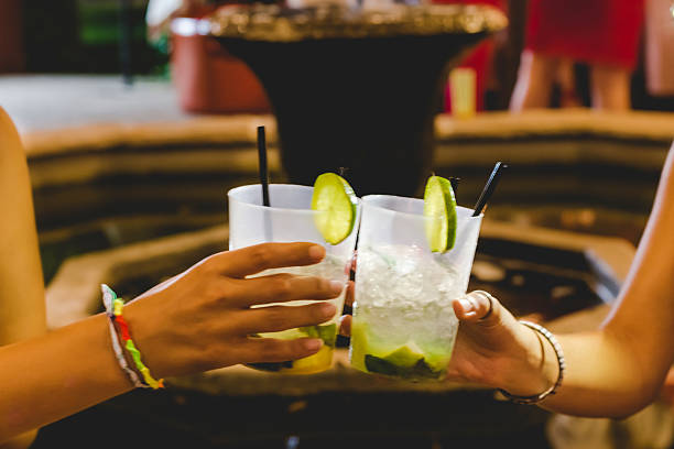 Two girls toast coctail in restaurant outdoor