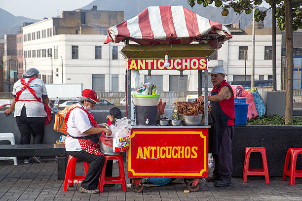 Lima, Peru - September 05, 2015: A man and a woman selling anticuchos with their food cart in the city center