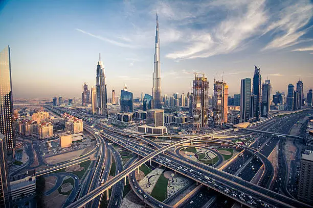 Dubai skyline with beautiful city close to it's busiest highway on traffic. Highway from Sarjah to Abudabi.