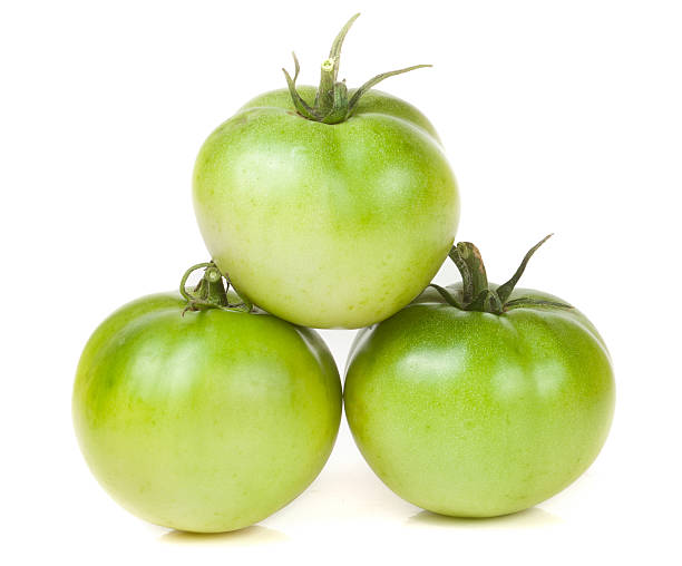 istock Three green unripe tomato isolated on white background 610952600