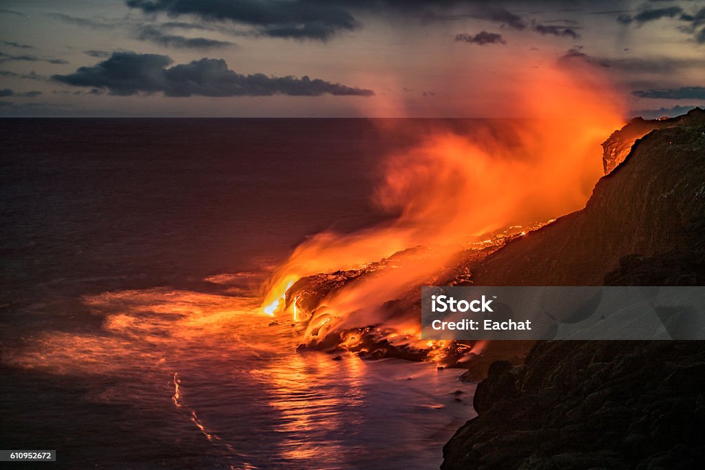 Hawaiian lava flow into the Pacific ocean Spectacular evening view of the lava from the Kilauea volcano, flowing in the Pacific ocean near Kalapana on the south coast of the Big Island of Hawaii. Big Island - Hawaii Islands Stock Photo