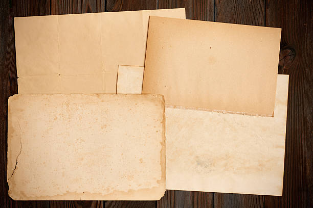 istock Vintage paper on textured old wooden background 610954386
