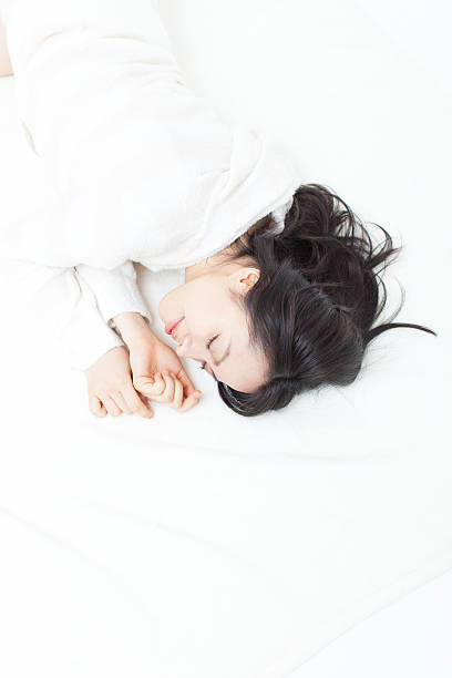 Japanese woman sleeping in the bed stock photo