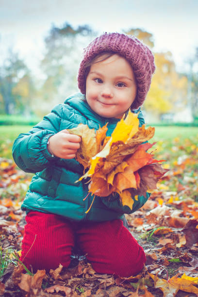 istock Little girl in autumn park 610955466