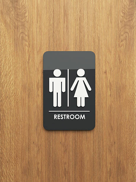 public restroom sign on the wood stock photo
