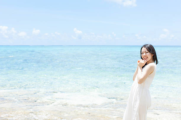 istock Japanese woman on the beach 610956302