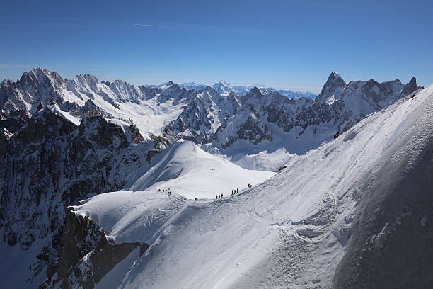 Extreme Skiing area Vallee Blanchet at Aiguille de Midi Chamonix-Mont-Blanc, France - May 20, 2016: Extreme Skiing area Vallee Blanchet at Aiguille de Midi (3842m) in the Mont Blanc Massif. They walk down to the start point for extreme back country skiing tours. aiguille de midi photos stock pictures, royalty-free photos & images