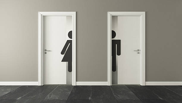 男性と女性のための白いトイレのドア - bathroom contemporary office sparse ストックフォトと画像