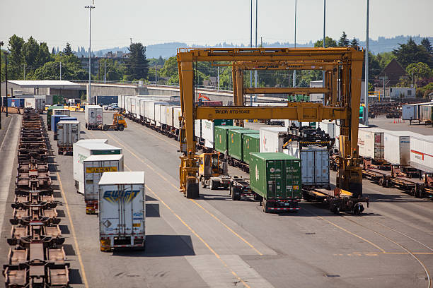 Intermodal freight conainers being moved with a gantry crane. stock photo