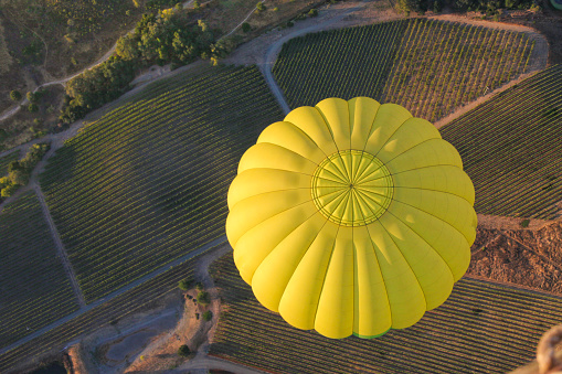 An aerial view of a hot air balloon floating over Napa Valley