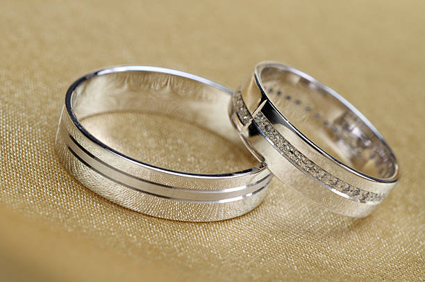istock Wedding bands on golden satin 610961020