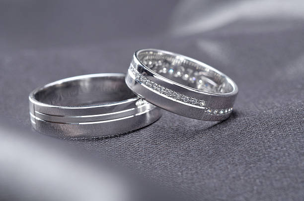 istock Two wedding rings on rustic wood, b&w 610961154