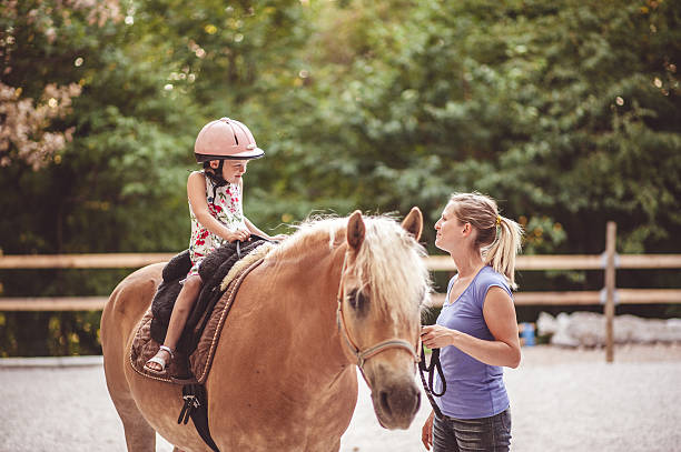 istock Little Girl Taking Horse-Riding Lessons 610963130