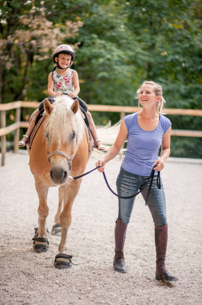 istock Little Girl Taking Horse-Riding Lessons 610963152