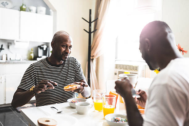istock homosexual couple doing breakfast on the kitchen togetherness 610963414