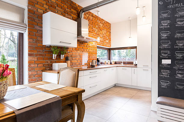 istock Spacious kitchen with white furniture 610964566