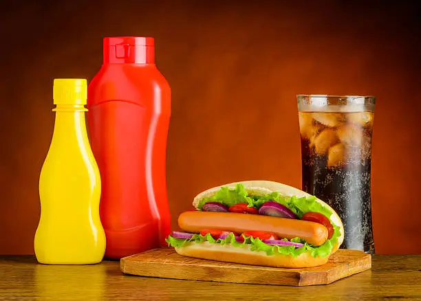 Hot Dog Sandwich with Ketchup, Mustard and Glass of Cold Cola with Ice