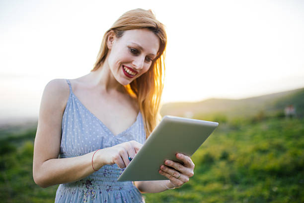 istock Girl with tablet in nature 610965106