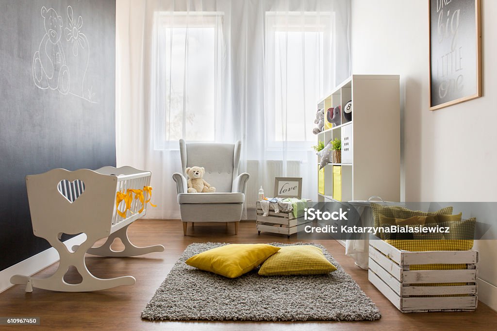 Infant baby room Lovely trendy nursery room with white minimalist furniture Nursery - Bedroom Stock Photo