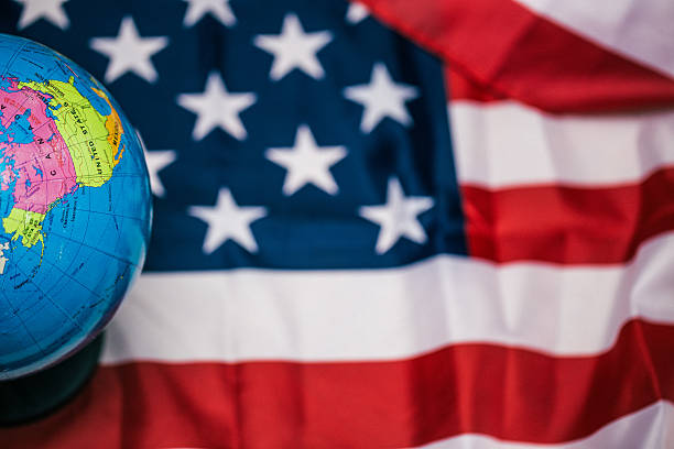 istock US flag with map of the world 610967584