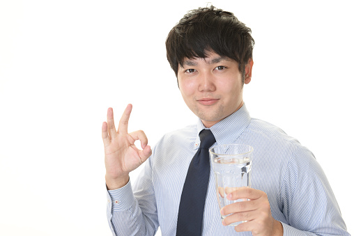 Portrait of handsome man drinking water
