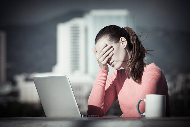 stressed out businesswoman on her computer - failure relationship difficulties computer women imagens e fotografias de stock