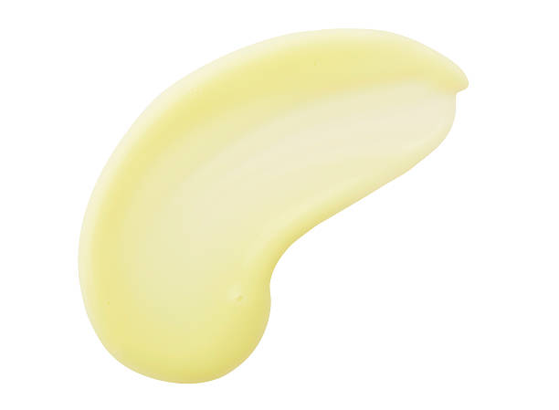 istock Yellow color cosmetic cream drop on background 610969074