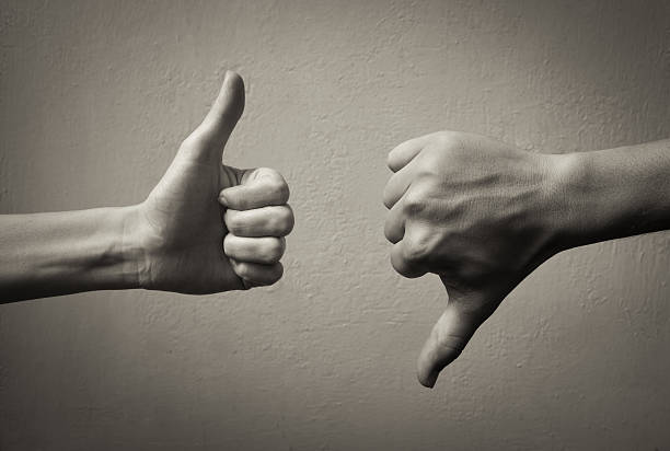 Thumbs up thumbs down. Yes and no concept.  rudeness stock pictures, royalty-free photos & images
