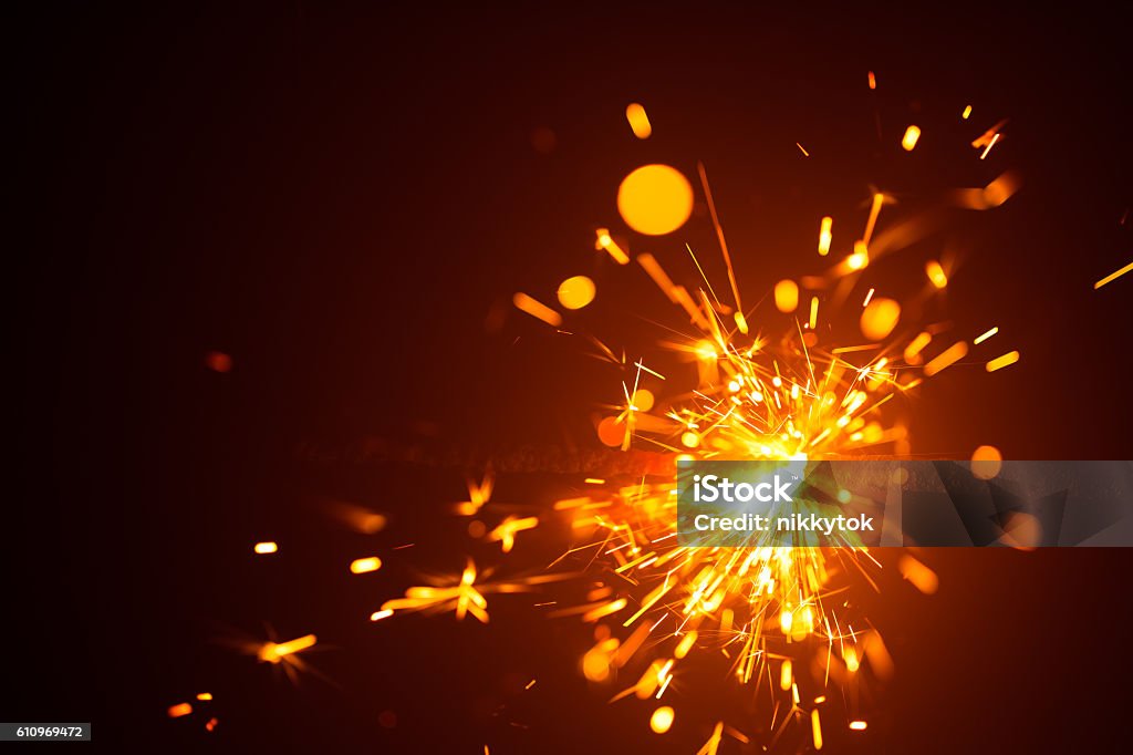Christmas sparkler in haze with red light Christmas sparkler in haze with red light, New Year background Sparks Stock Photo