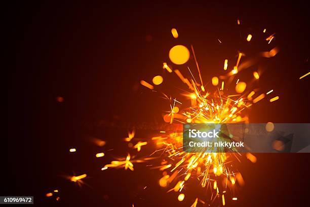 Christmas Sparkler In Haze With Red Light Stock Photo - Download Image Now - Sparks, Abstract, Close-up