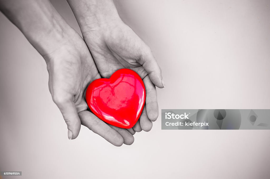Hand holding heart Hand holding beautiful heart. Giving Stock Photo