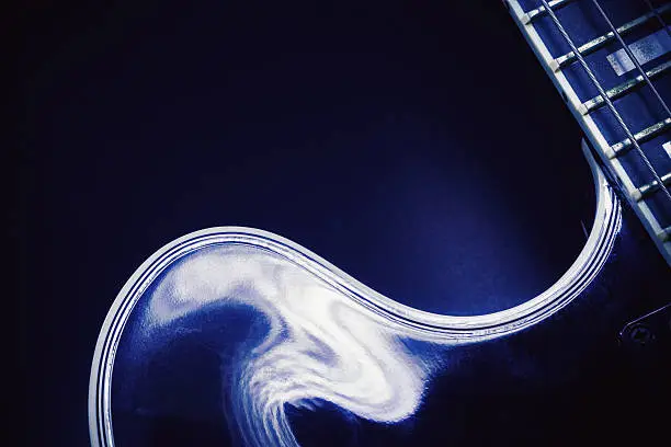 Part of an electric guitar, closeup view.