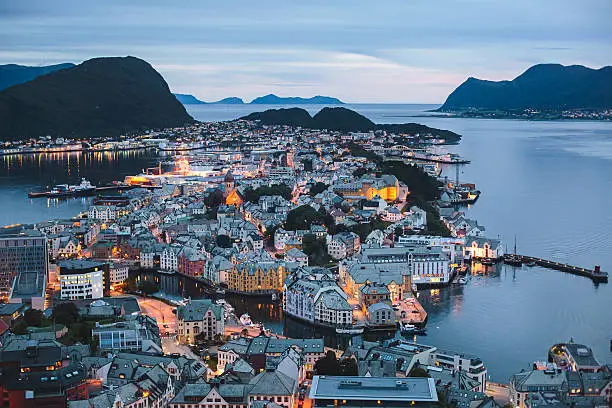 Beautiful super wide-angle summer aerial view of Alesund, Norway, with skyline and scenery beyond the city, seen from the observation deck of Aksla mountain