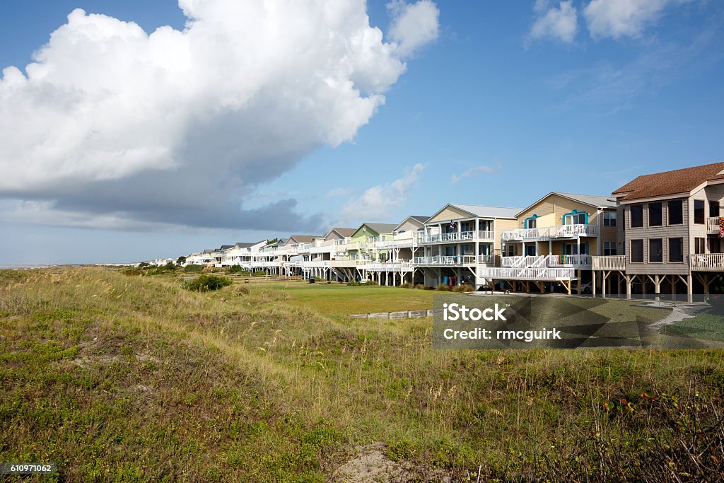 Beach houses Luxury beach vacation houses across the green sand dunes, in Sunset Beach, North Carolina.  Beach Stock Photo