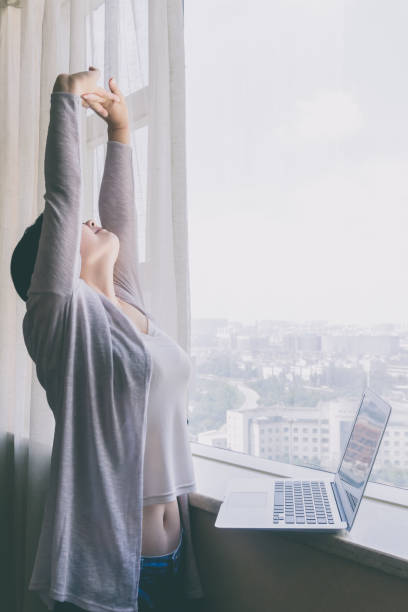 Businesswoman stretching and looking up stock photo
